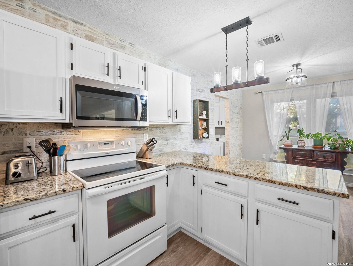 3620 Chestnut Court Cibolo, TX 78108 - Photo 8 of 45 a kitchen with granite countertop white cabinets stainless steel appliances and a sink