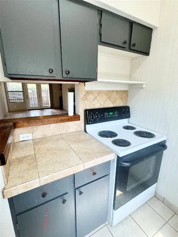 a kitchen with a stove and a microwave