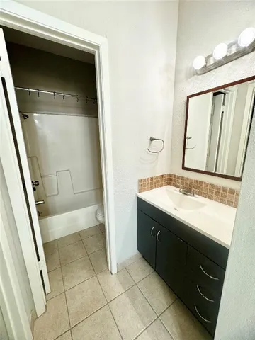 a bathroom with a sink a mirror and a bathtub