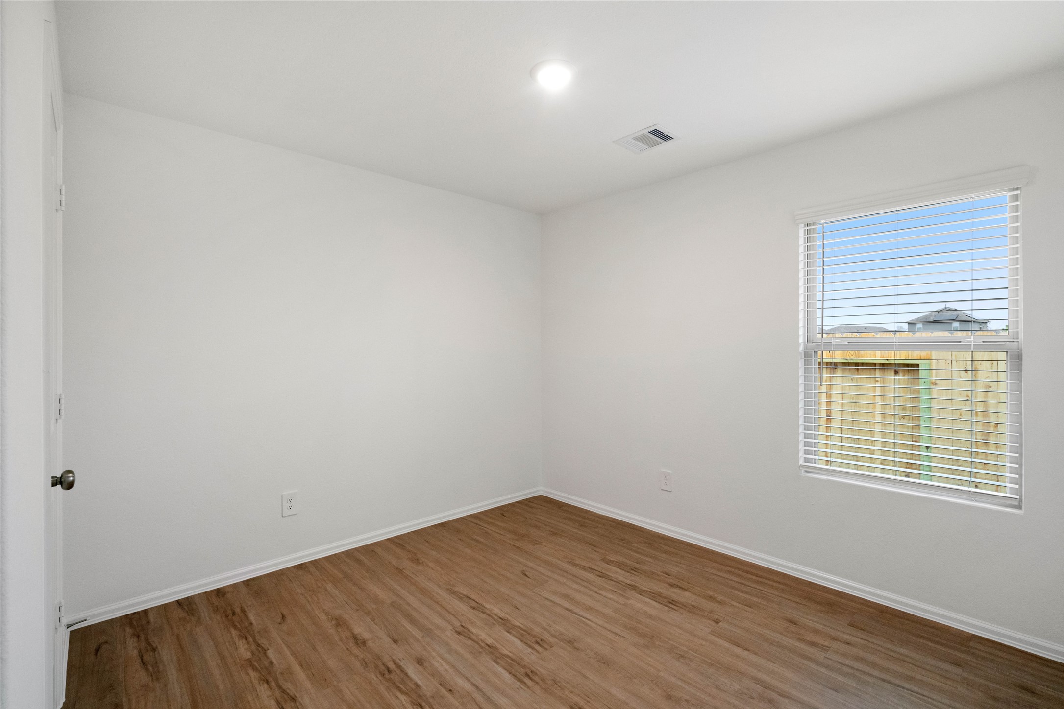 104 Pine Bend Magnolia, TX 77354 - Photo 15 of 25 a view of an empty room with wooden floor and a window