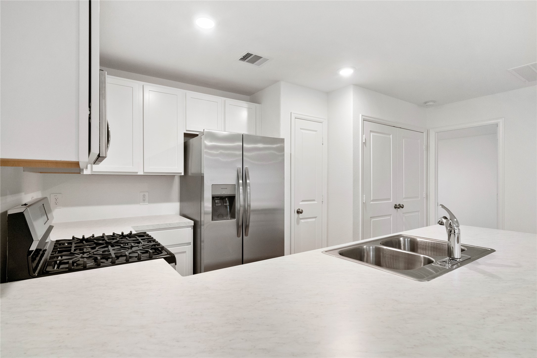 104 Pine Bend Magnolia, TX 77354 - Photo 7 of 25 a kitchen with a refrigerator and a sink