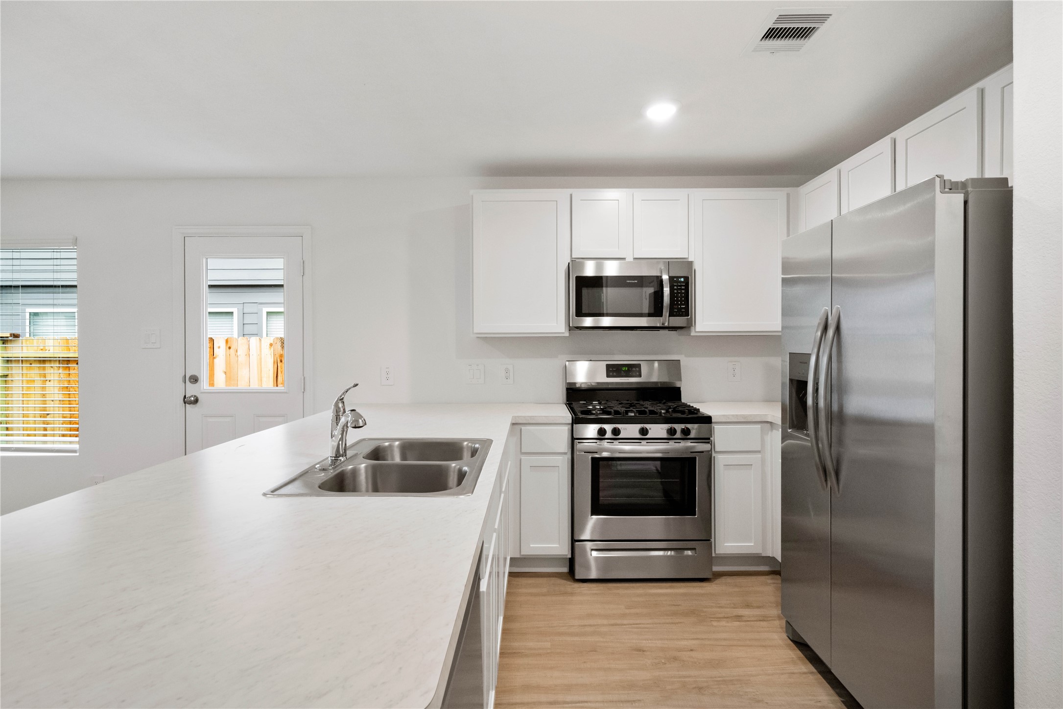104 Pine Bend Magnolia, TX 77354 - Photo 8 of 25 a kitchen with a refrigerator sink and stove