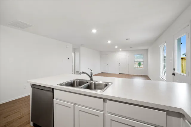 a kitchen with a sink and cabinets
