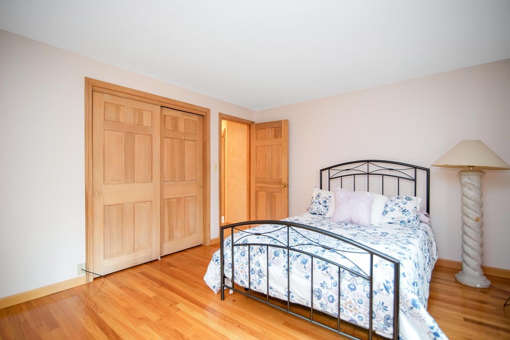 660 Ridge Road Wilbraham, MA 01095 - Photo 23 of 31 a bedroom with a bed with wooden floor