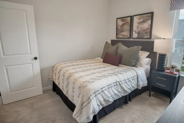 a bedroom with a large bed and a balcony