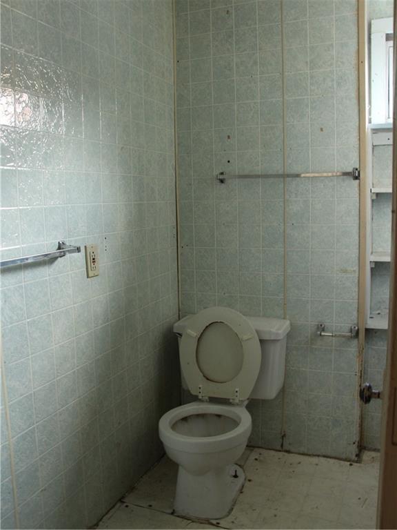 344-346 3rd Street California, PA 15419 - Photo 11 of 21 a bathroom with a granite countertop toilet a sink and a shower