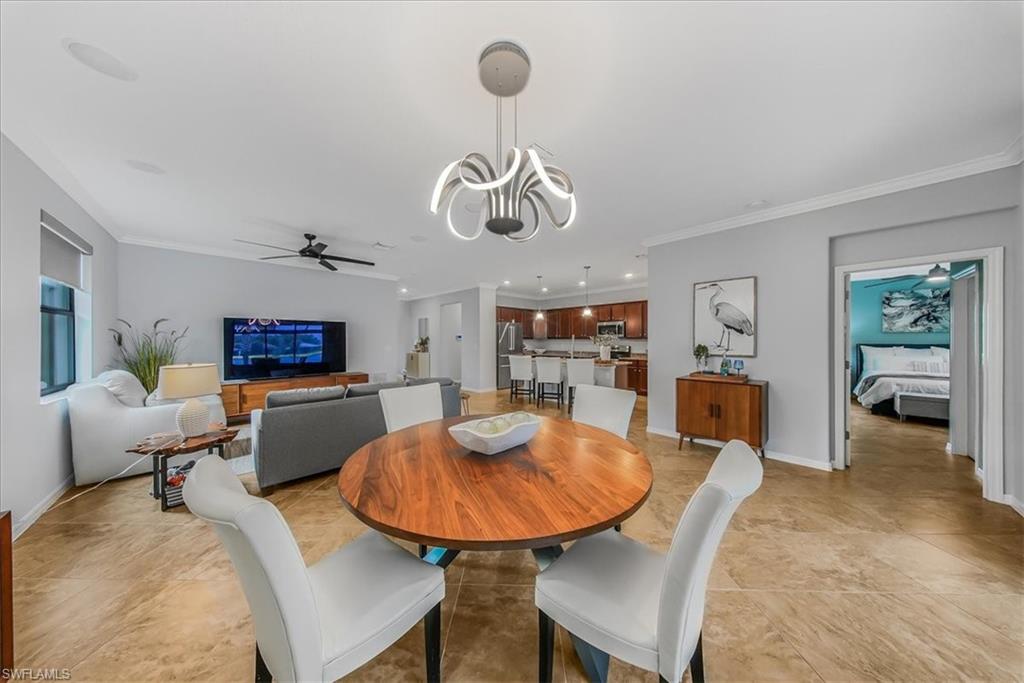 19862 Bittersweet Lane Estero, FL 33928 - Photo 14 of 50 a living room with furniture a rug and a chandelier