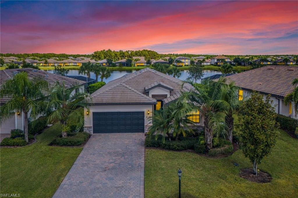 19862 Bittersweet Lane Estero, FL 33928 - Photo 2 of 50 a front view of a house with a yard