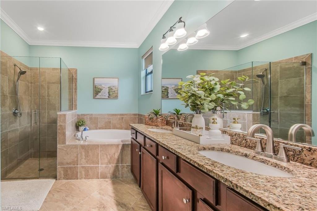 19862 Bittersweet Lane Estero, FL 33928 - Photo 21 of 50 a bathroom with a granite countertop sink a large mirror and shower