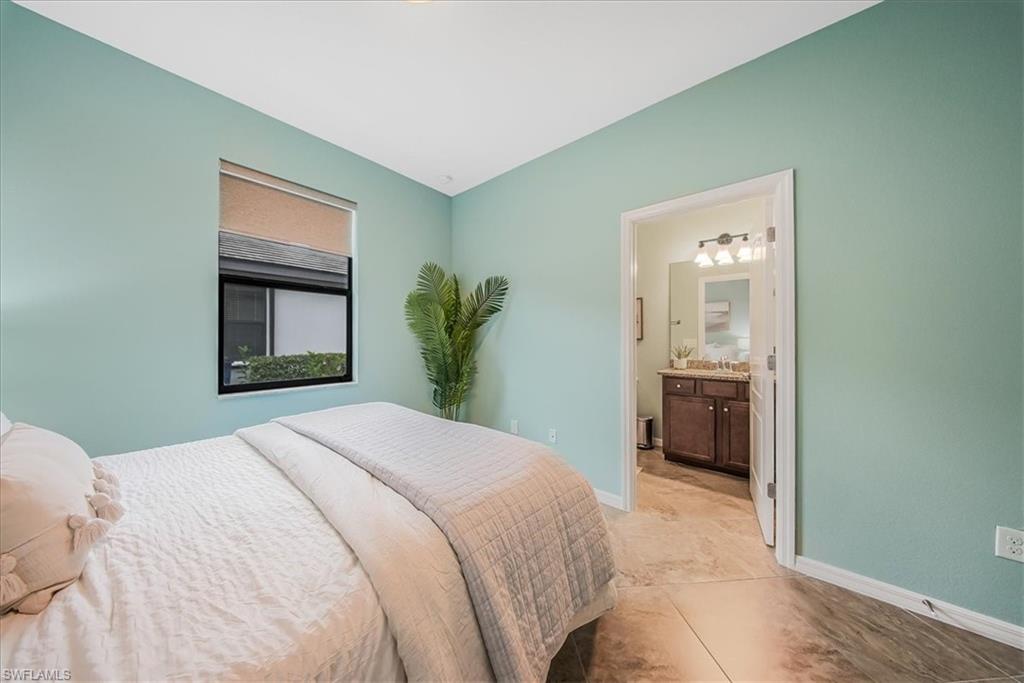 19862 Bittersweet Lane Estero, FL 33928 - Photo 23 of 50 Bedroom 2 with ensuite bath and light tile patterned floors