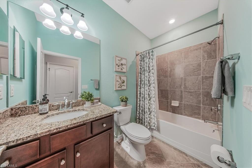 19862 Bittersweet Lane Estero, FL 33928 - Photo 26 of 50 a bathroom with a granite countertop sink toilet and shower