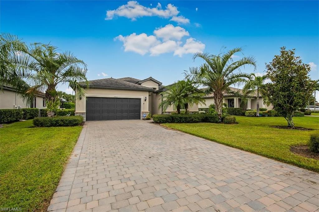 19862 Bittersweet Lane Estero, FL 33928 - Photo 32 of 50 a front view of a house with garden