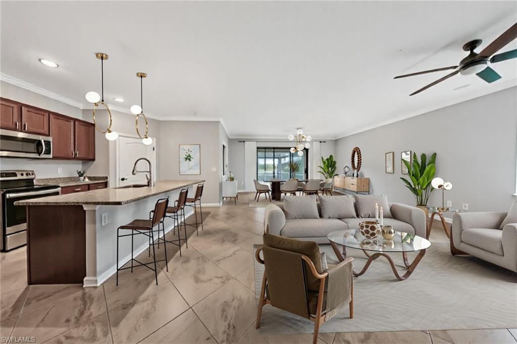 19862 Bittersweet Lane Estero, FL 33928 - Photo 8 of 50 a living room with furniture kitchen view and a chandelier