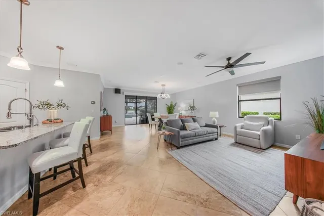 a kitchen with stainless steel appliances granite countertop a sink a stove and a wooden floors