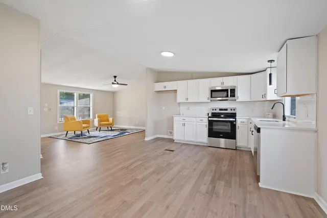 a kitchen with sink cabinets and stainless steel appliances
