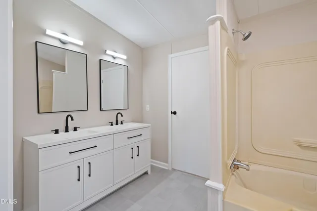 a bathroom with a double vanity sink mirror and