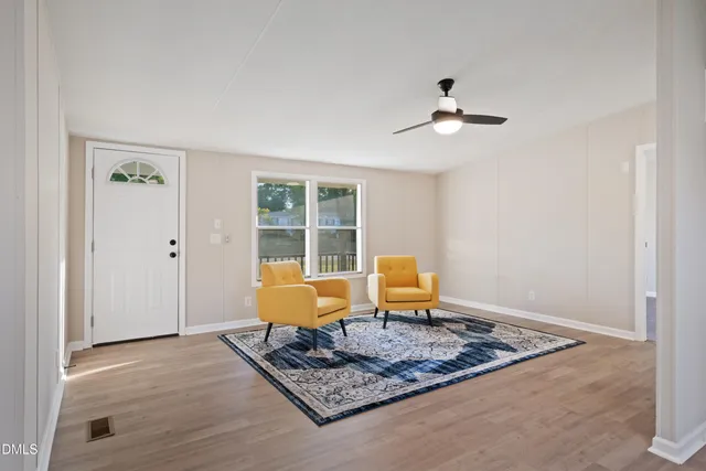 a living room with furniture rug and window