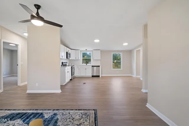 a view of kitchen and hall with wooden floor