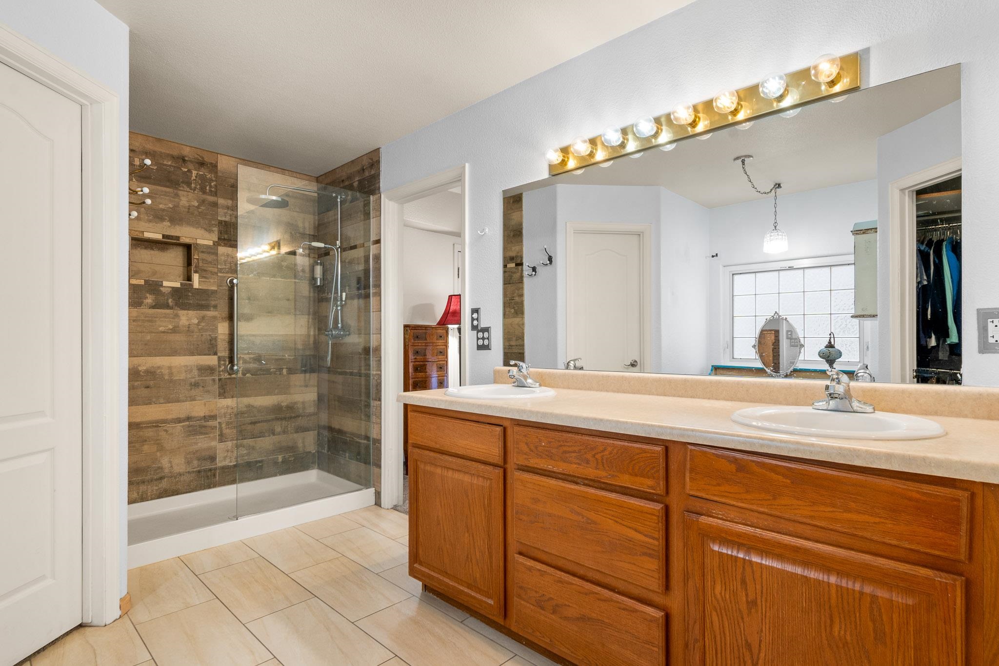 398 Butte Court Grand Junction, CO 81507 - Photo 13 of 33 a bathroom with a shower sink and mirror