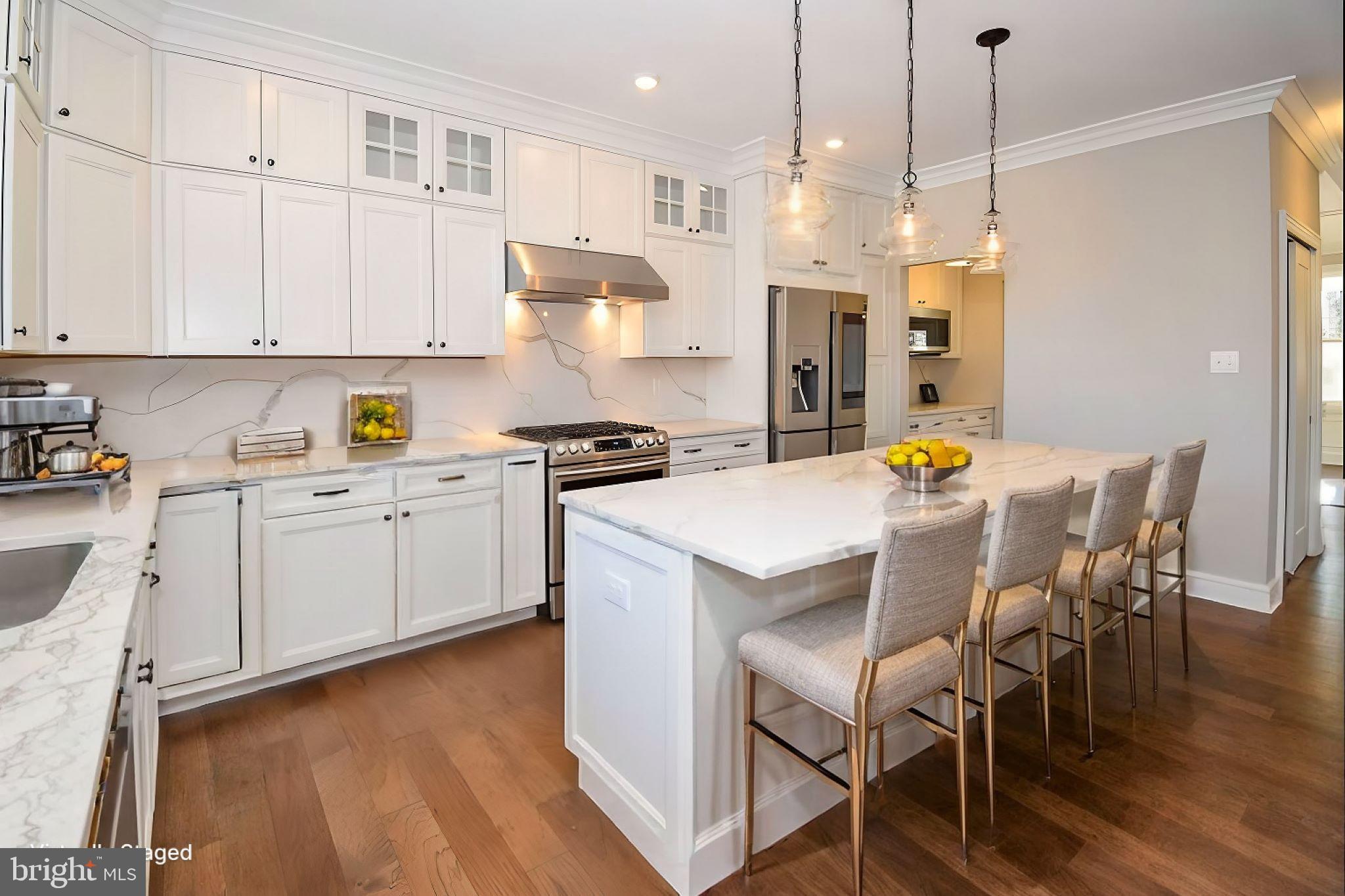 51 Edison Road Cherry Hill, NJ 08034 - Photo 13 of 22 a kitchen with stainless steel appliances a white table chairs and a refrigerator