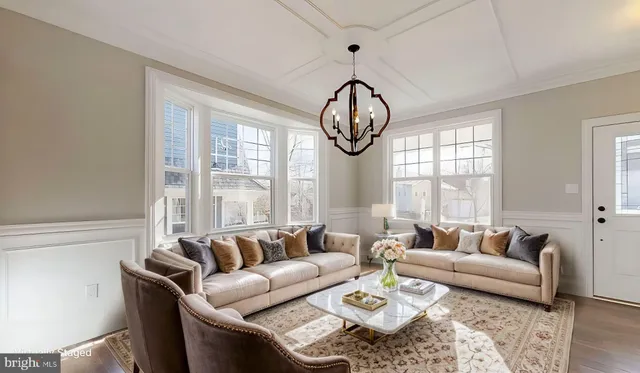 a living room with furniture and floor to ceiling windows