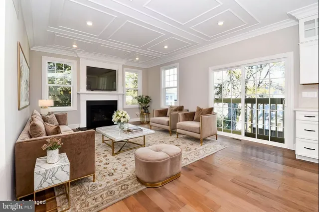 a living room with furniture fireplace and a large window
