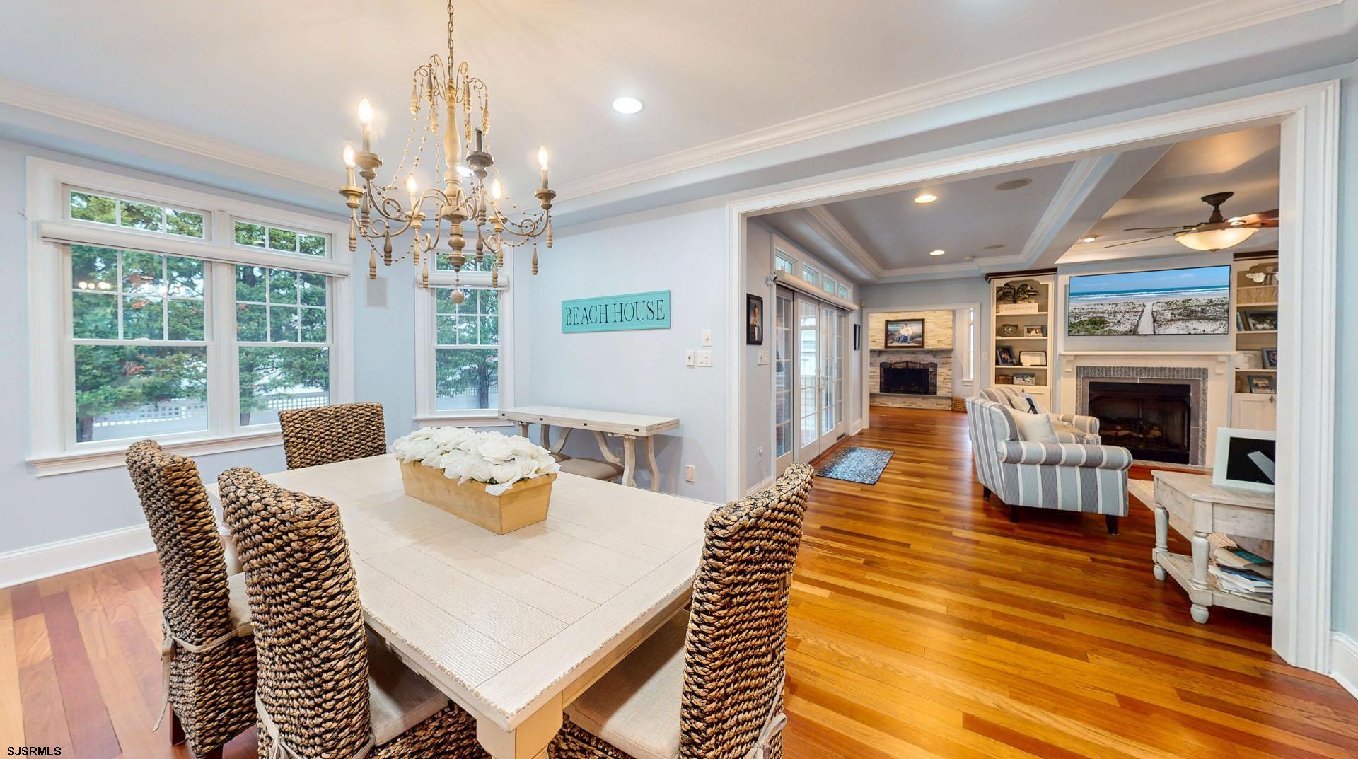 53 Bay Road Ocean City, NJ 08226 - Photo 14 of 68 a view of a dining room with furniture a chandelier and wooden floor
