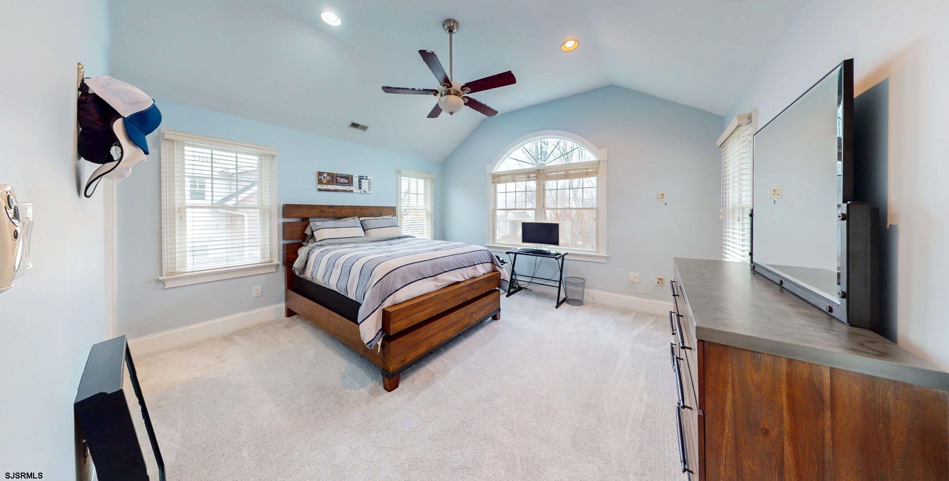 53 Bay Road Ocean City, NJ 08226 - Photo 23 of 68 a spacious bedroom with a bed window and a flat tv screen
