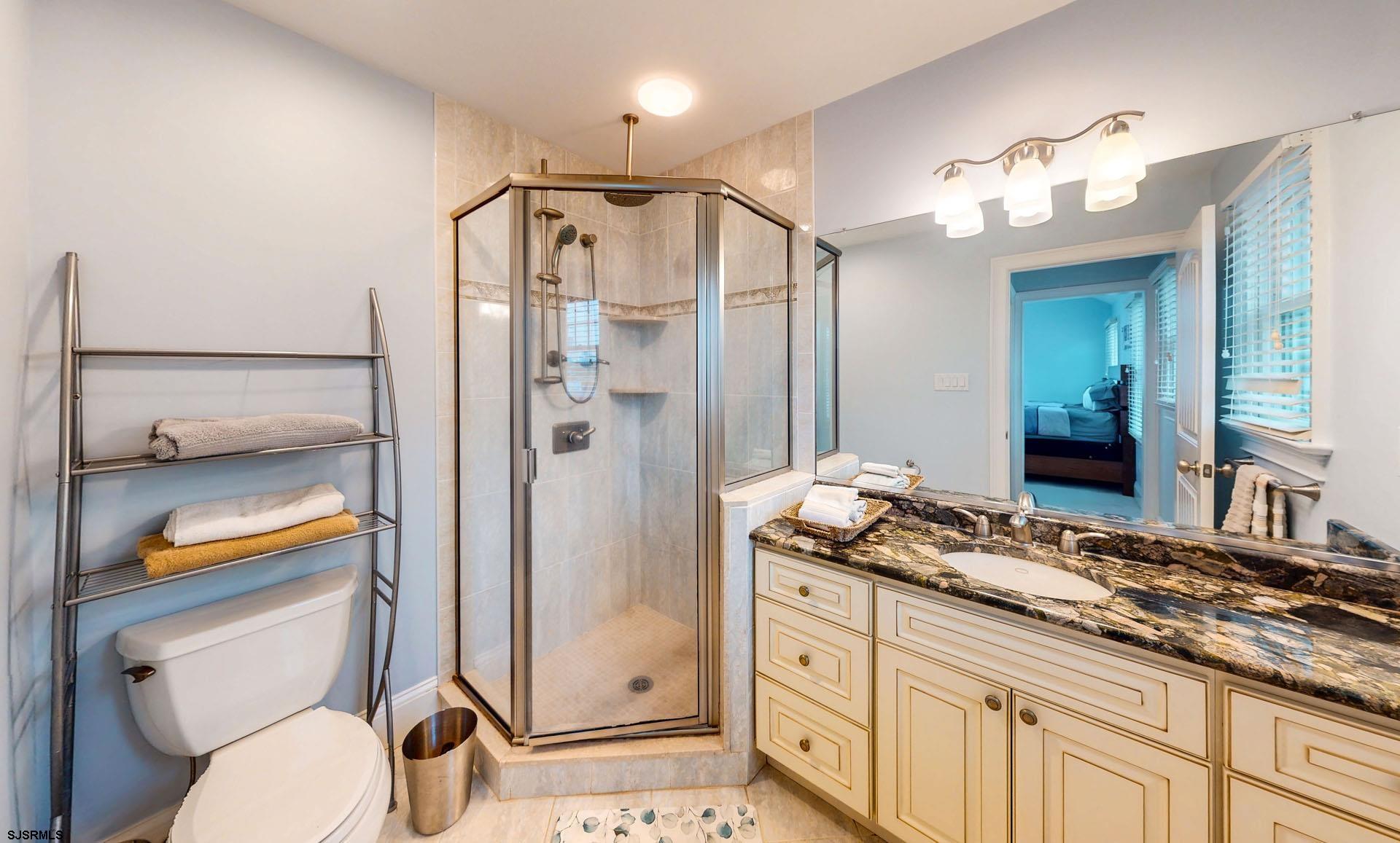 53 Bay Road Ocean City, NJ 08226 - Photo 26 of 68 a bathroom with a granite countertop sink toilet and shower