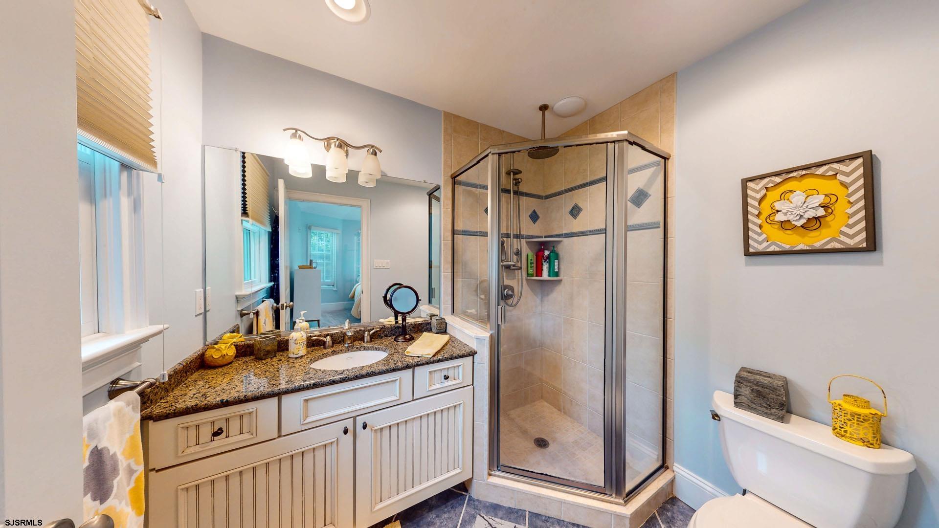 53 Bay Road Ocean City, NJ 08226 - Photo 34 of 68 a bathroom with a granite countertop sink mirror vanity and toilet