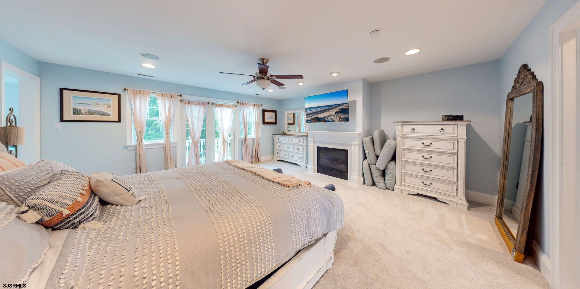 53 Bay Road Ocean City, NJ 08226 - Photo 35 of 68 a spacious bedroom with a bed and a flat screen tv