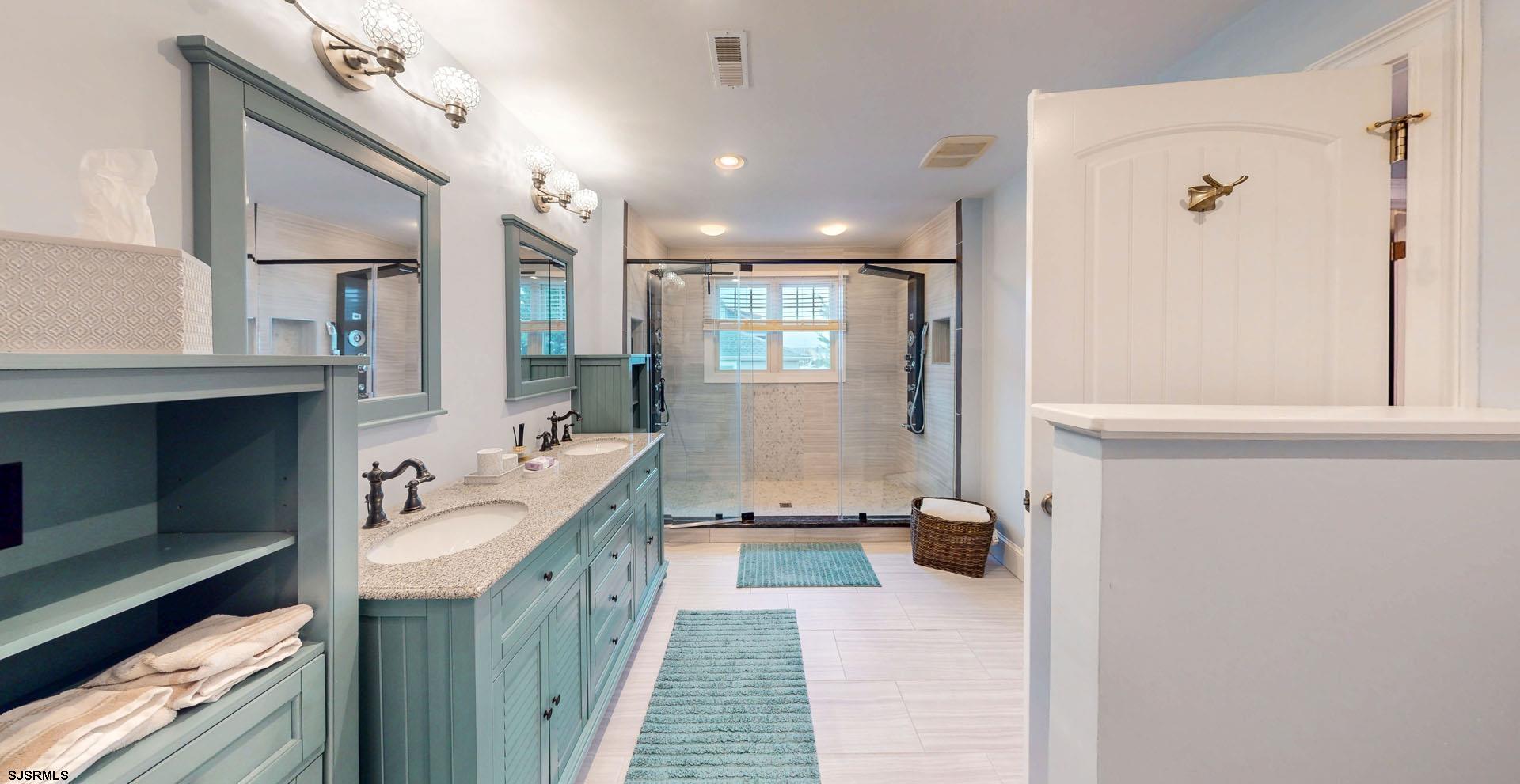 53 Bay Road Ocean City, NJ 08226 - Photo 42 of 68 a bathroom with a double vanity sink a mirror and a shower