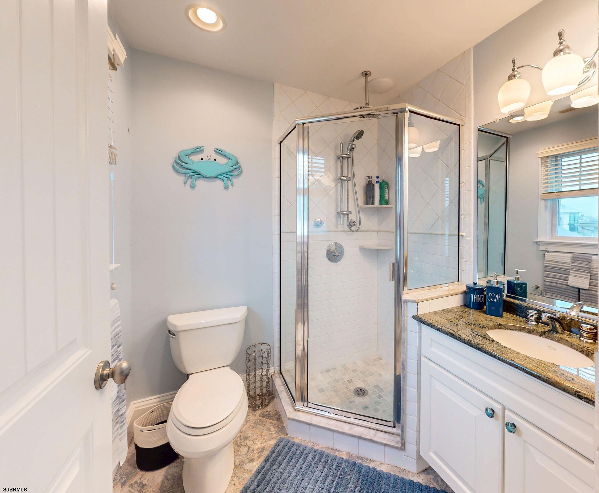 53 Bay Road Ocean City, NJ 08226 - Photo 48 of 68 a bathroom with a granite countertop sink toilet and shower