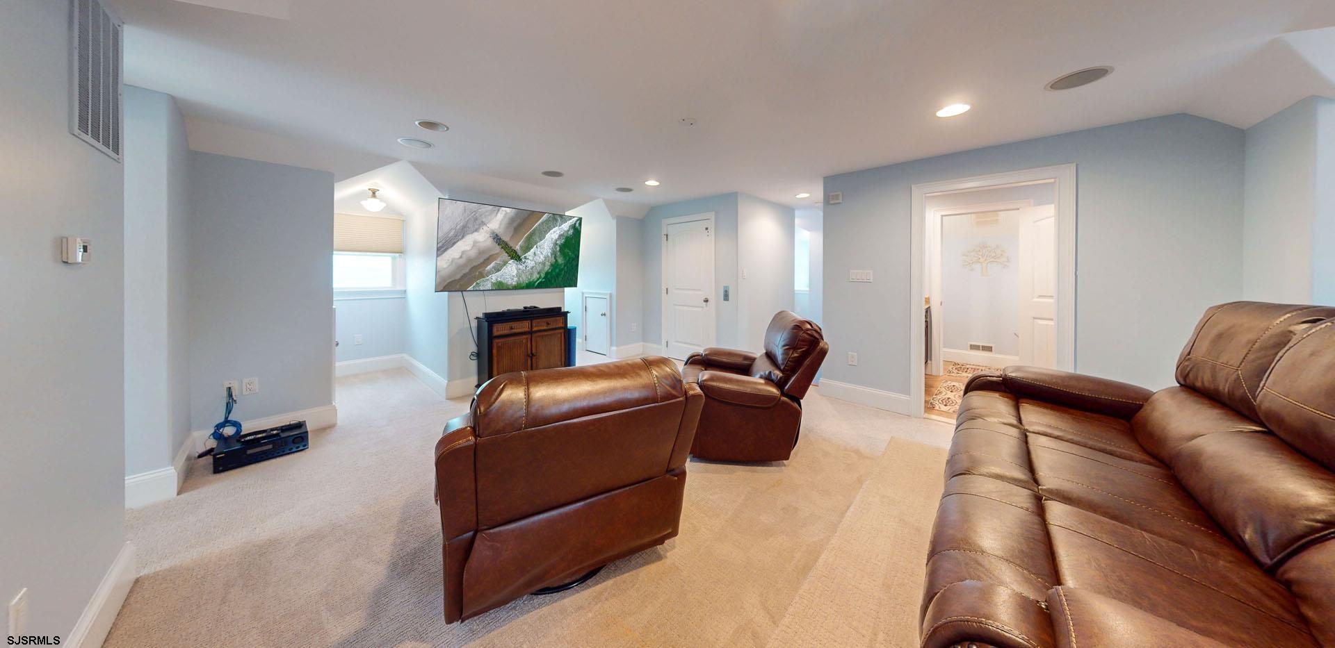 53 Bay Road Ocean City, NJ 08226 - Photo 53 of 68 a living room with furniture a flat screen tv and a fireplace