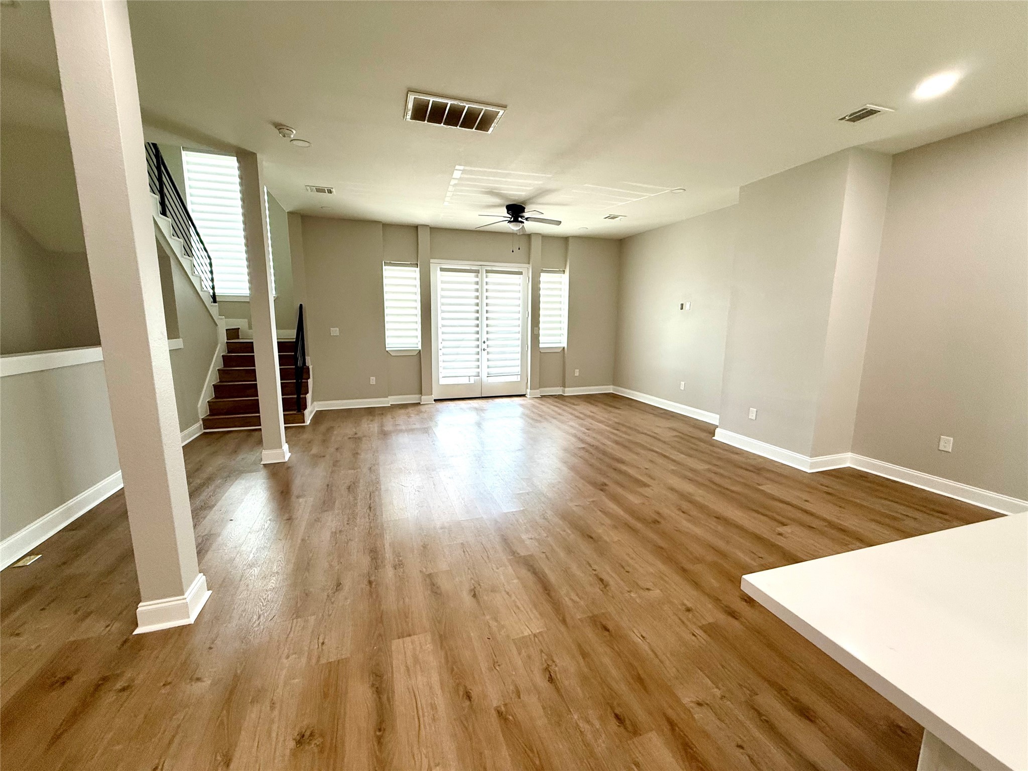 3526 Luca Street Houston, TX 77021 - Photo 3 of 9 an empty room with wooden floor and windows