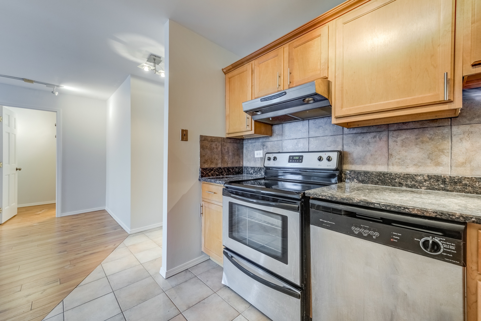 655 West Irving Park Road, Unit 5011 Chicago, IL 60613 - Photo 12 of 23 a kitchen with granite countertop a stove and a sink