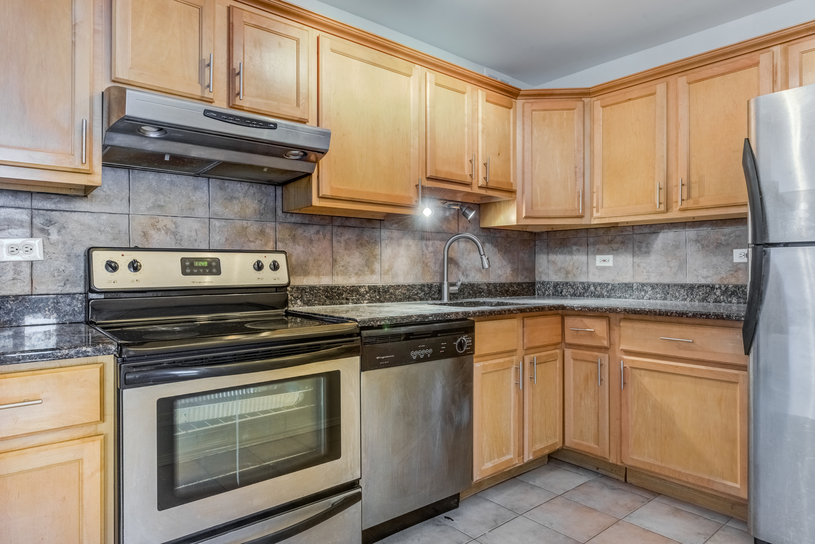 655 West Irving Park Road, Unit 5011 Chicago, IL 60613 - Photo 13 of 23 a kitchen with granite countertop cabinets stainless steel appliances and a sink