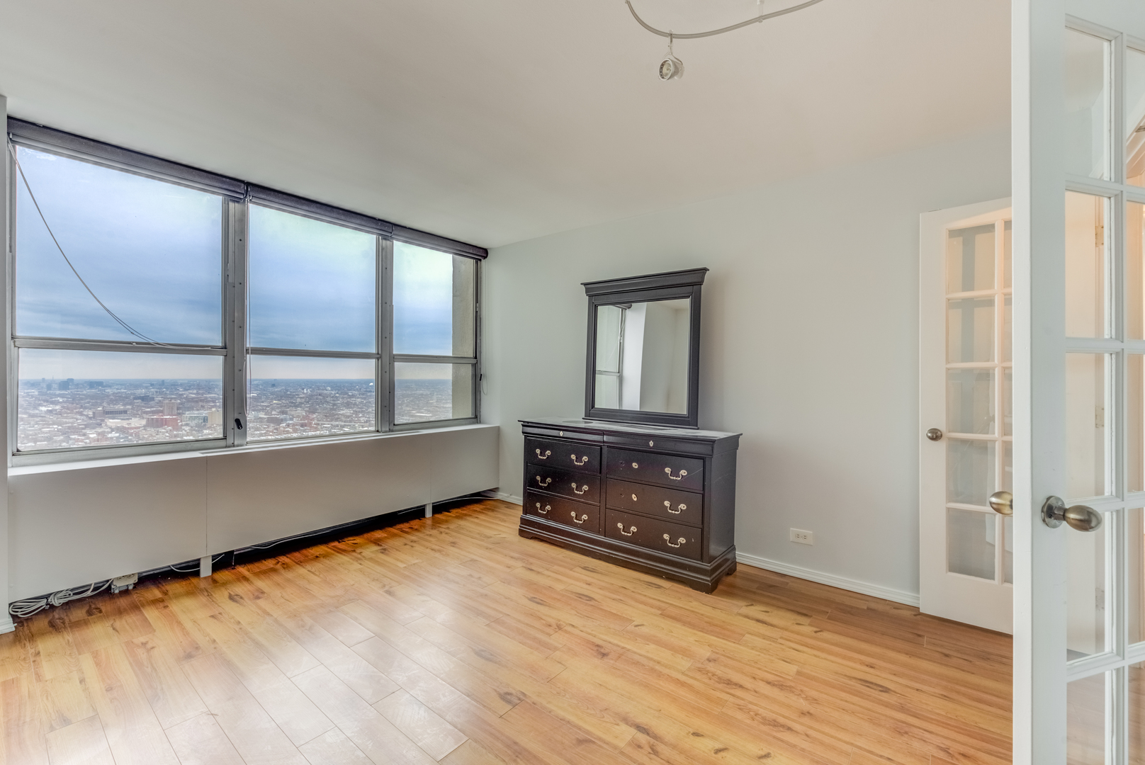 655 West Irving Park Road, Unit 5011 Chicago, IL 60613 - Photo 15 of 23 an empty room with wooden floor and windows