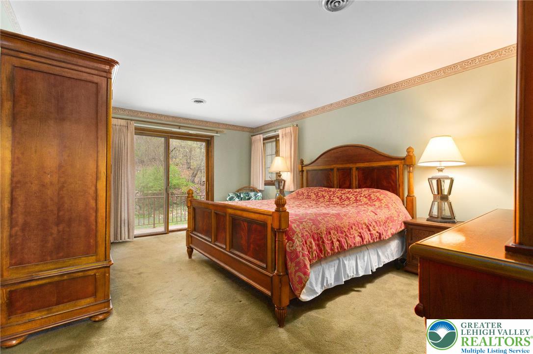 79 Country Club Road Ashland, PA 17921 - Photo 26 of 47 a bedroom with a bed lamp and a large window