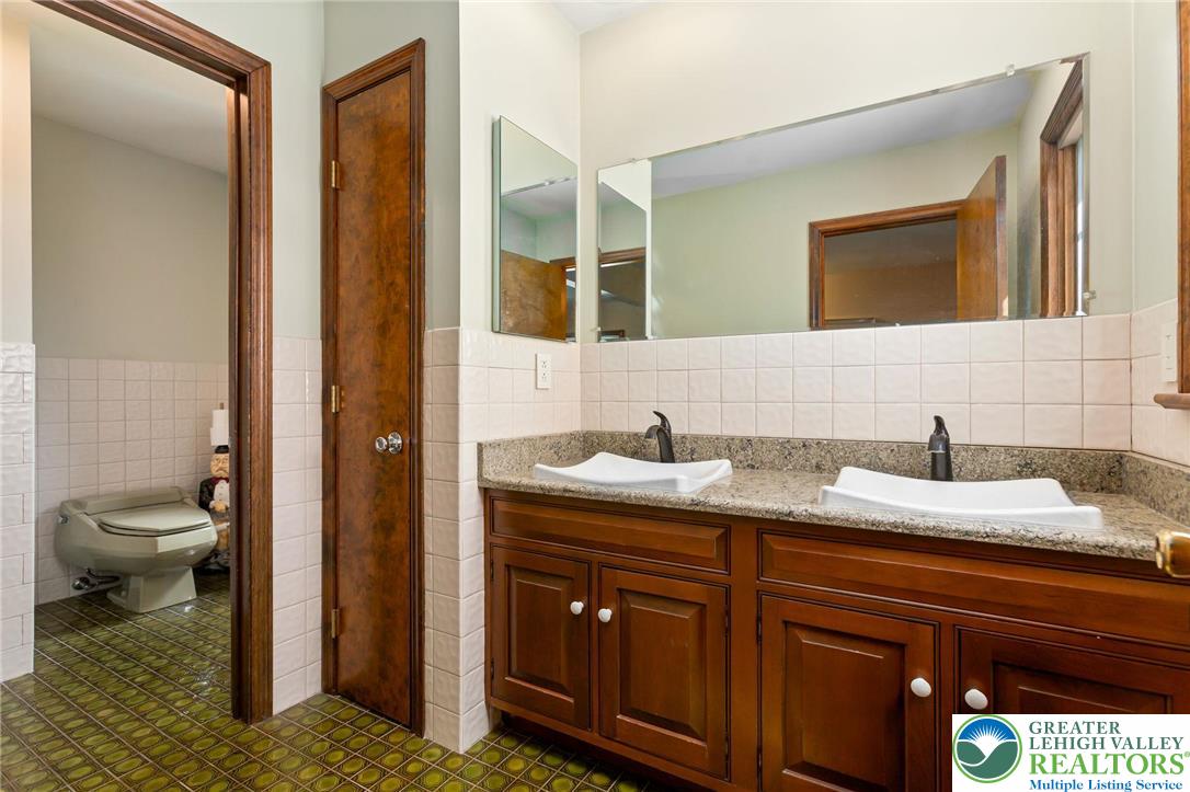79 Country Club Road Ashland, PA 17921 - Photo 35 of 47 a en suite bathroom with a granite countertop sink and a mirror