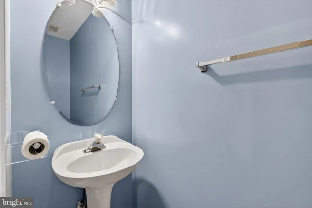 a bathroom with a sink a mirror and vanity