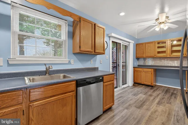 a kitchen with a sink cabinets stainless steel appliances and a window