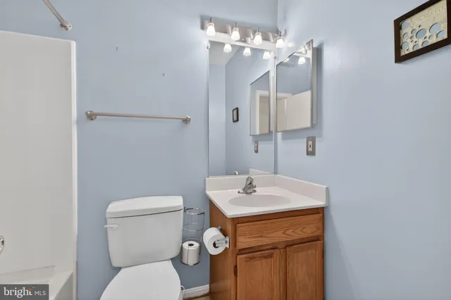 a bathroom with a sink a toilet and mirror