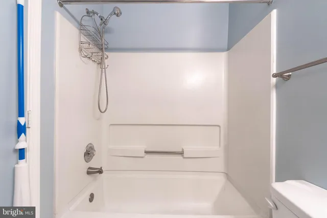 a bathroom with a bath tub with a shower