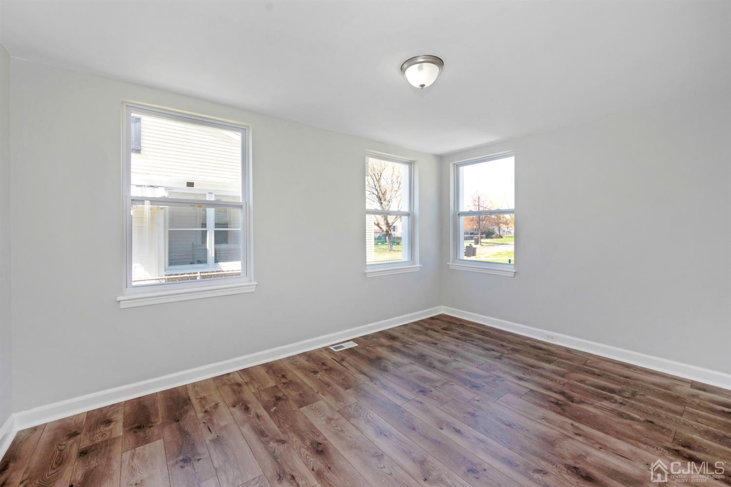 811 Columbus Road Burlington, NJ 08016 - Photo 8 of 18 an empty room with wooden floor and windows
