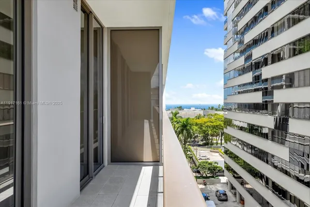 a view of balcony with wooden floor and fence
