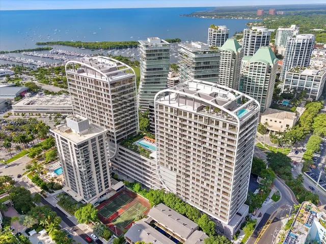 a front view of a building with a garden