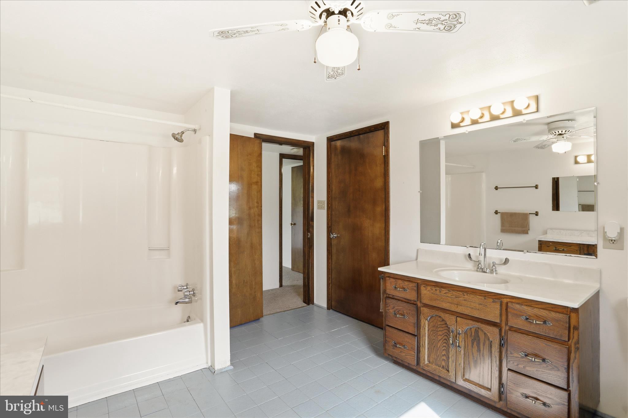 12623 Windy Ridge Drive Mount Savage, MD 21545 - Photo 44 of 72 a spacious bathroom with a double vanity sink a mirror and a bathtub