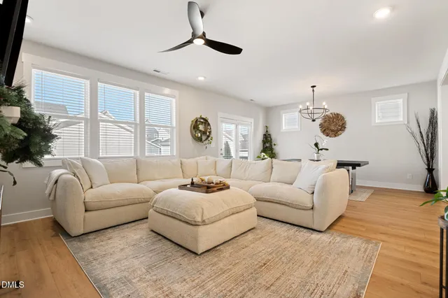 a living room with furniture ceiling fan and a rug