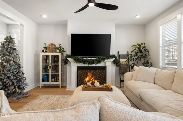 a living room with furniture a flat screen tv and a fireplace